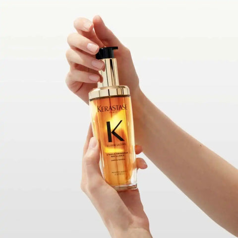 Kérastase Elixir Ultime Original Hair Oil 75ml in a clear refillable bottle, showcasing a luxurious hair treatment oil.