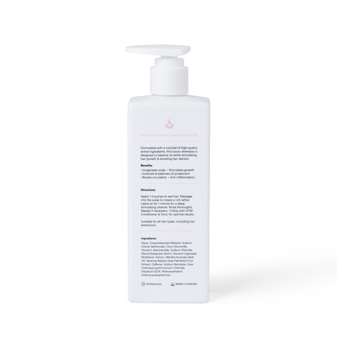 Stïm Haircare stimulating shampoo bottle with sleek design and label, showcasing a nourishing hair care product.