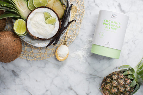 Skindles coconut, pineapple, and lime scented candle in a 290g jar, showcasing the tropical candle with colorful label.