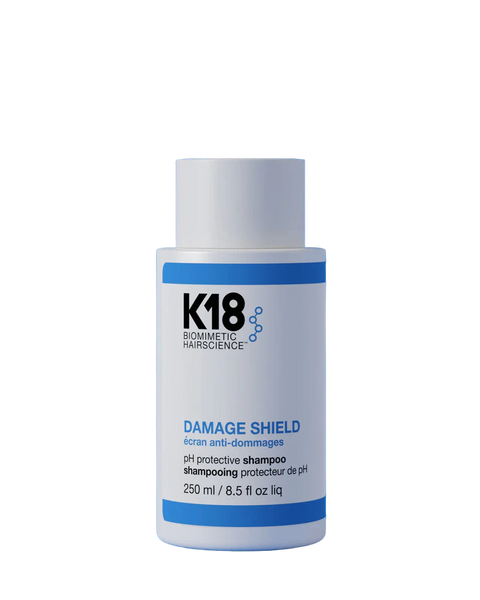 K18 Damage Shield pH protective shampoo in 8.5 oz blue bottle, designed to repair and shield damaged hair.