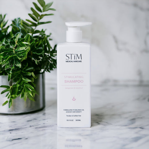 Stïm Haircare stimulating shampoo bottle with sleek packaging, designed to invigorate scalp and promote healthy hair growth.