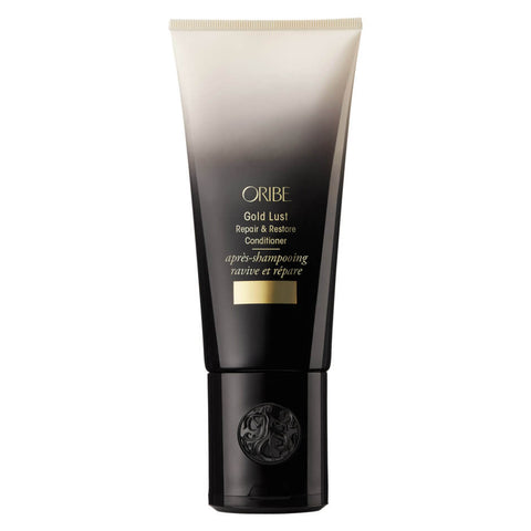 Oribe Gold Lust shampoo, conditioner, and hair oil bundle displayed with sleek bottles and luxurious packaging.