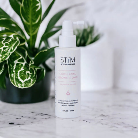Stïm Haircare Stimulating Growth Tonïc bottle with dropper, showcasing the product's packaging and label.
