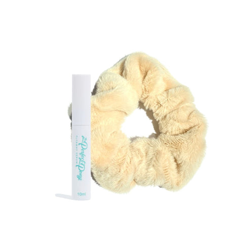 Close-up of soft, fluffy hair scrunchies from Perfect Pony Hair with a bottle of Flyaway Serum for smooth, shiny hair.