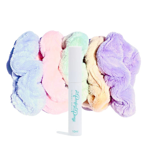 Creamy white super soft fluffy scrunchies and flyaway serum from Perfect Pony Hair displayed on a neutral background.