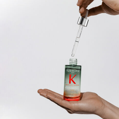 Kérastase Genesis Homme anti-hair fall serum for men in 90ml bottle, with the serum shown in hand, promoting strong, healthy hair.
