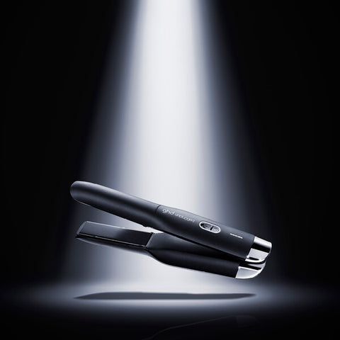 GHD Unplugged Black straightener with sleek design, featuring ceramic plates for smooth styling and easy handling.