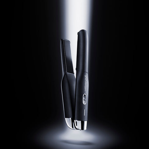 GHD Unplugged Black cordless straightener with sleek black design and ceramic plates for smooth styling.